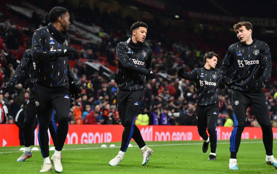 Manchester United's Anthony Elanga, Jadon Sancho and Victor Lindelof during the warm up before the match - Peter Powell/Reuters