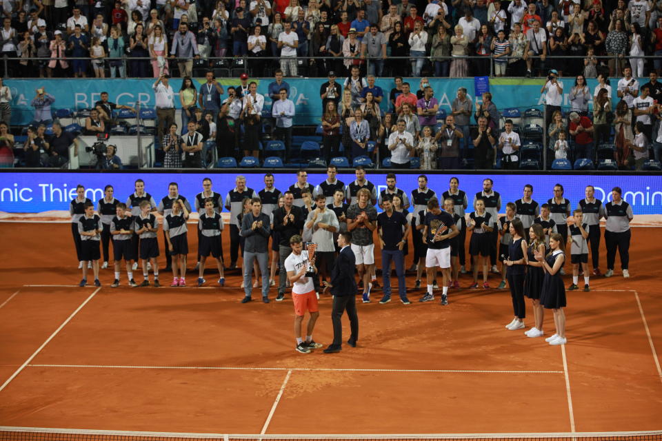 Dominic Thiem (Front L) celebrates by raising the trophy after winning the final match against Filip Krajinovic.