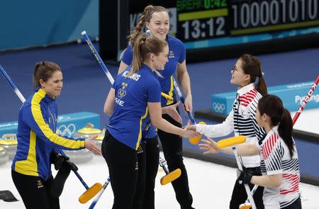 Curling - Pyeongchang 2018 Winter Olympics - Women's Final - Sweden v South Korea - Gangneung Curling Center - Gangneung, South Korea - February 25, 2018 - Agnes Knochenhauer of Sweden shakes hands with Kim Seon-yeong of South Korea after Sweden won the final. REUTERS/Cathal McNaughton