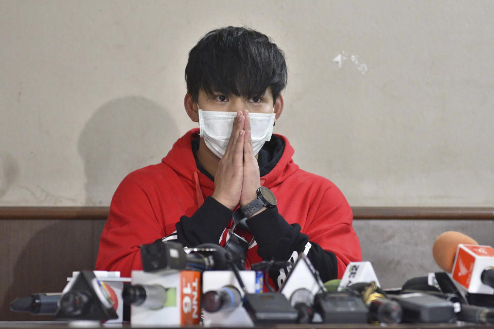 In this Sept. 18, 2019, photo, Ratchadech Wongtabut talks to reporters at the Bukkhalo Police Station in Bangkok, Thailand. Police have arrested Ratchadech the male model accused of taking an unconscious woman home, boasting online about his sexual exploits, and leaving her lifeless body in the lobby of his building. (AP Photo)