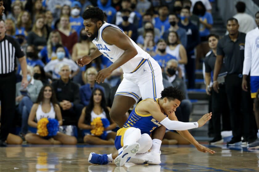 UCLA forward Cody Riley (2) collides with Cal State Bakersfield guard Grehlon Easter (5) during the first half of an NCAA college basketball game Tuesday, Nov. 9, 2021, in Los Angeles. (AP Photo/Ringo H.W. Chiu)