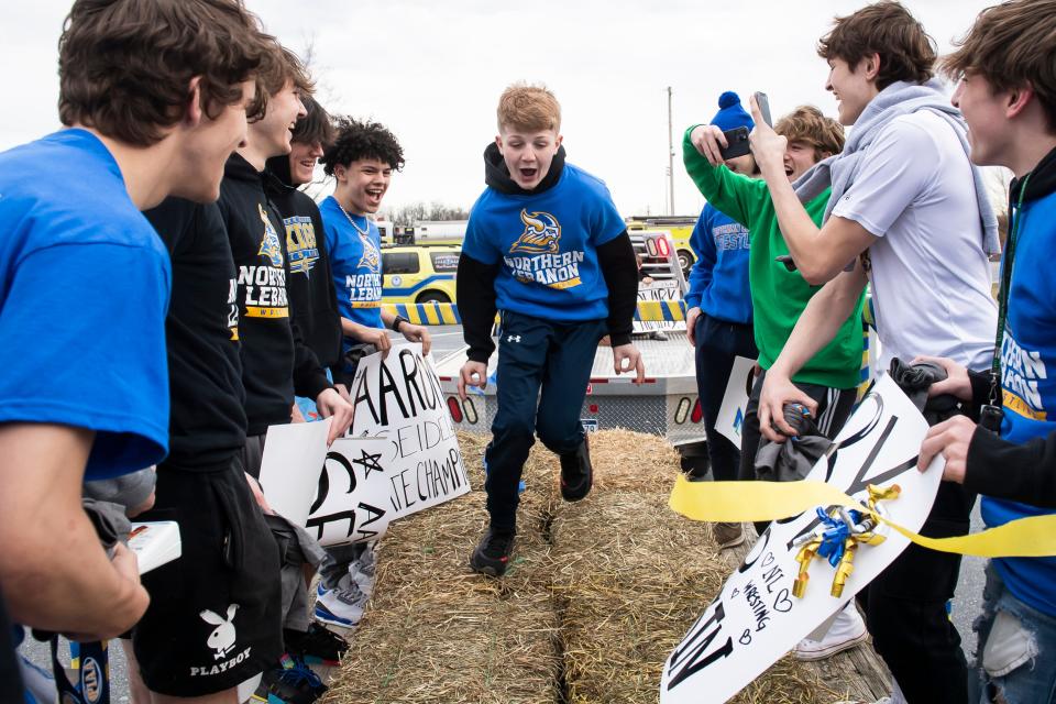 Northern Lebanon wrestler Aaron Seidel dances between his teammates before the start of a parade convoy last March. Seidel, then a freshman, won the PIAA Class 2A championship title at 106 pounds.