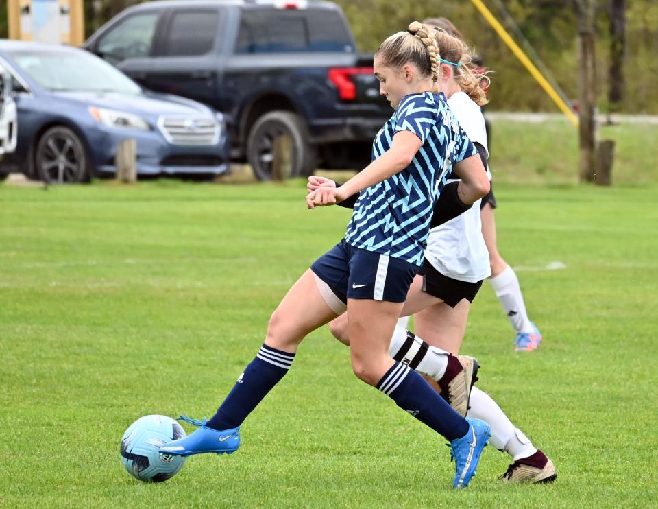 Petoskey's Clara Mailloux competes for the ball with a Marquette player Saturday at the Click Road Soccer Complex.