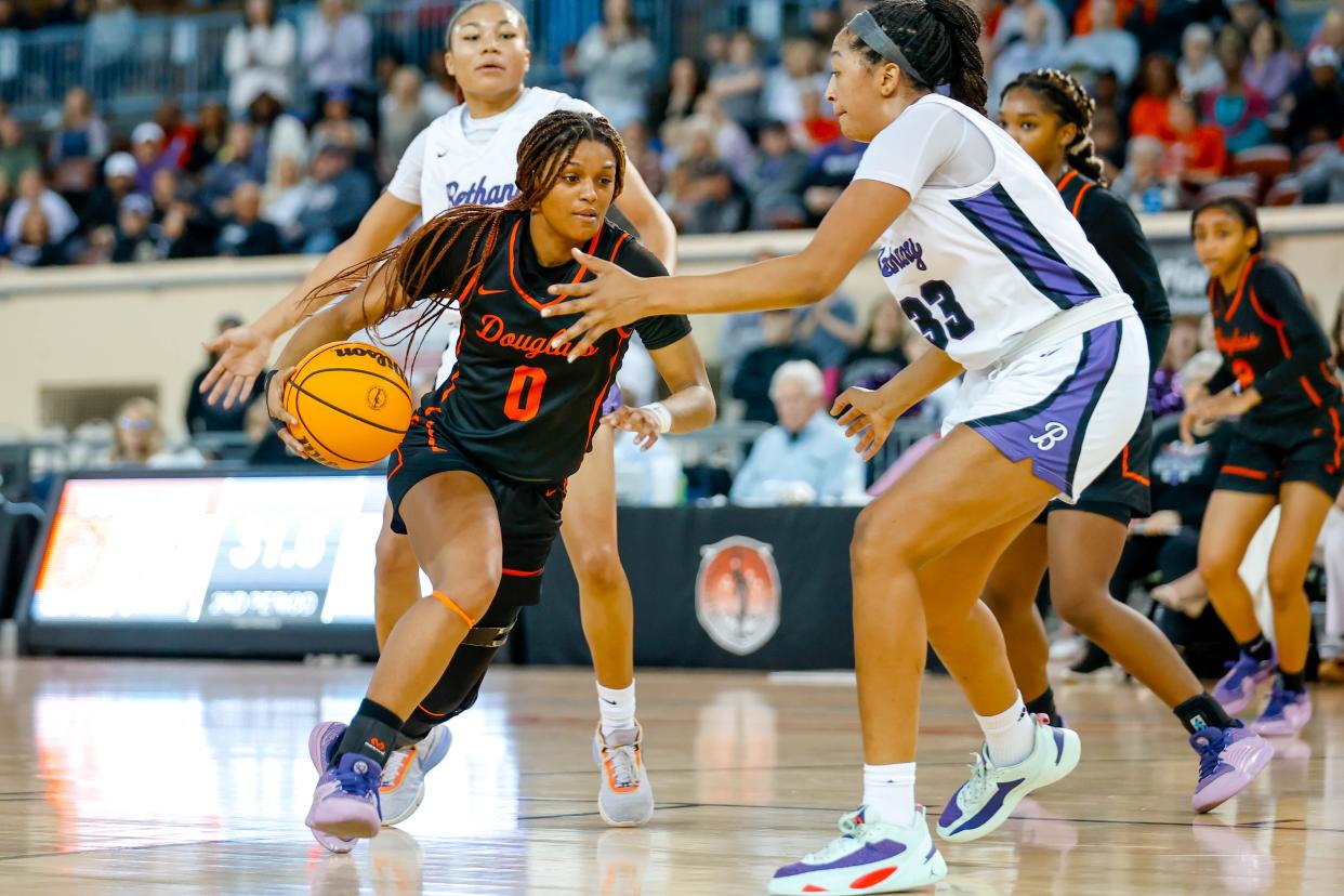 Douglass’ Kiara Smith (0) tries to work past Bethany’s Talia Vann (33) during the semifinals of the girls state basketball tournament between Bethany and Douglass at the Jim Norick Arena in Oklahoma City, on Friday, March 8, 2024.