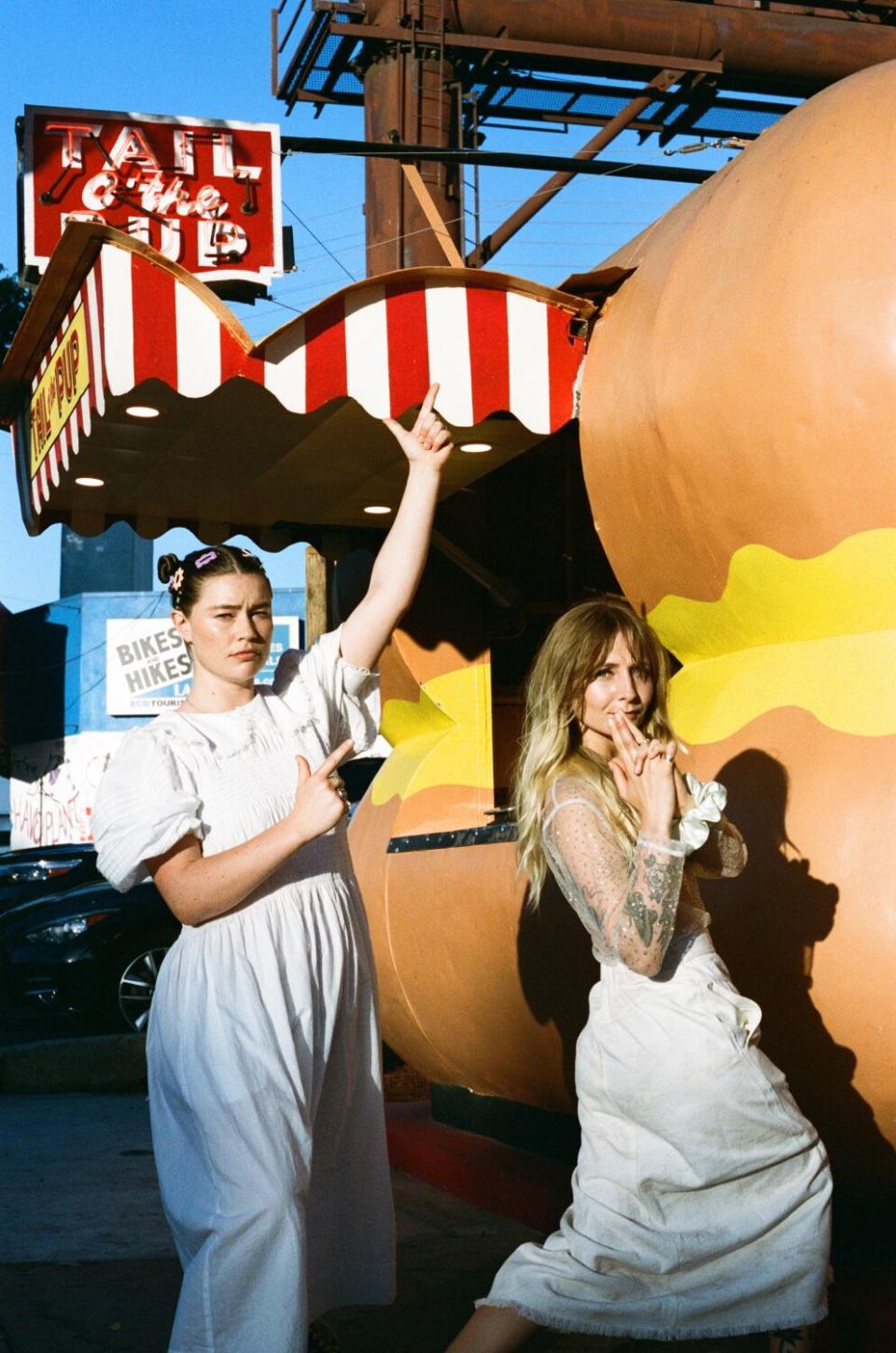 Rhian Teasdale (left) and Hester Chambers (right) of the indie rock duo Wet Leg outside Tail o' the Pup Hot Dog Stand.