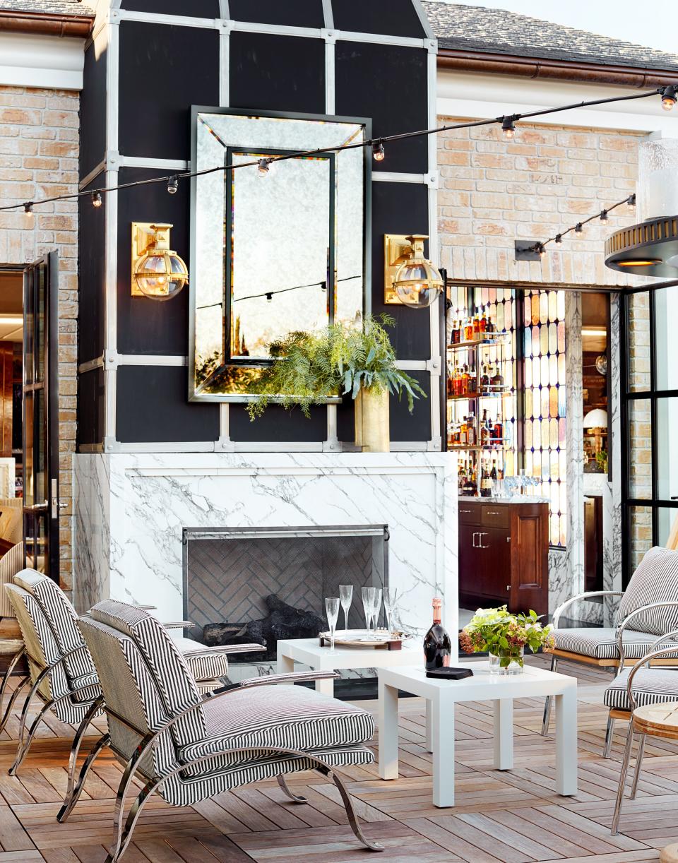 The terrace chairs wear a striped fabric from Rose Tarlow. Light fixtures by Urban Archaeology; custom mirror.