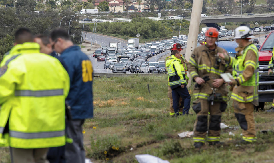 Southbound traffic backed up after a bus rolled down an embankment off Interstate 15 in North San Diego County Saturday, Feb. 22, 2020, killing several people and injuring others. Emergency crews rescued several people trapped in the wreckage after the bus crashed around 10:20 a.m. on State Route 76, about 45 miles (72 kilometers) north of San Diego, the North County Fire Protection District said. (Don Boomer/The San Diego Union-Tribune via AP)