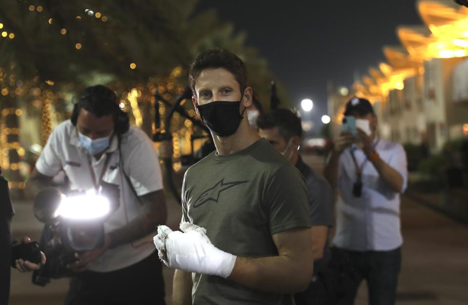 FILE - Haas driver Romain Grosjean of France arrives to the paddock to thank the marshals in Bahrain International Circuit in Sakhir, Bahrain, in this Thursday, Dec. 3, 2020, file photo. Grosjean escaped with only minor burns when his Haas car exploded into a fireball after crashing on the first lap at the Bahrain GP. Mercedes announced Wednesday, May 5, 2021, that Grosjean will drive Lewis Hamilton’s 2019 championship-winning car at the French Grand Prix on June 27 before a full test day at Circuit Paul Ricard two days later. (AP Photo/Kamran Jebreili, File)