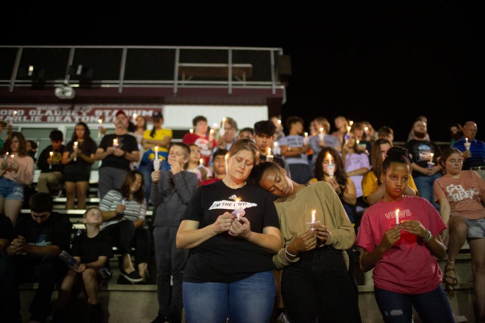 Families gather in prayer during a vigil for Battle Creek Middle School sixth-grader Kailee Grace Warren at Spring Hill High School in Spring Hill, Tenn., on Wednesday, Oct. 13, 2021.