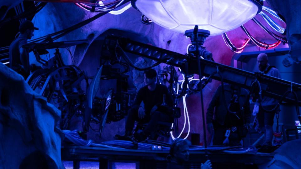 Shun Oguri sits upon a purple set in a behind the scenes shot from Godzilla vs. Kong.