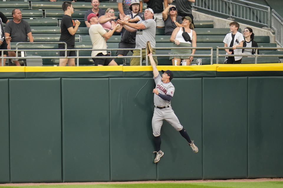 Cleveland Guardians center fielder Will Brennan jumps but cannot get to Chicago White Sox's Luis Robert Jr.'s home run ball during the first inning of a baseball game Friday, July 28, 2023, in Chicago. (AP Photo/Erin Hooley)