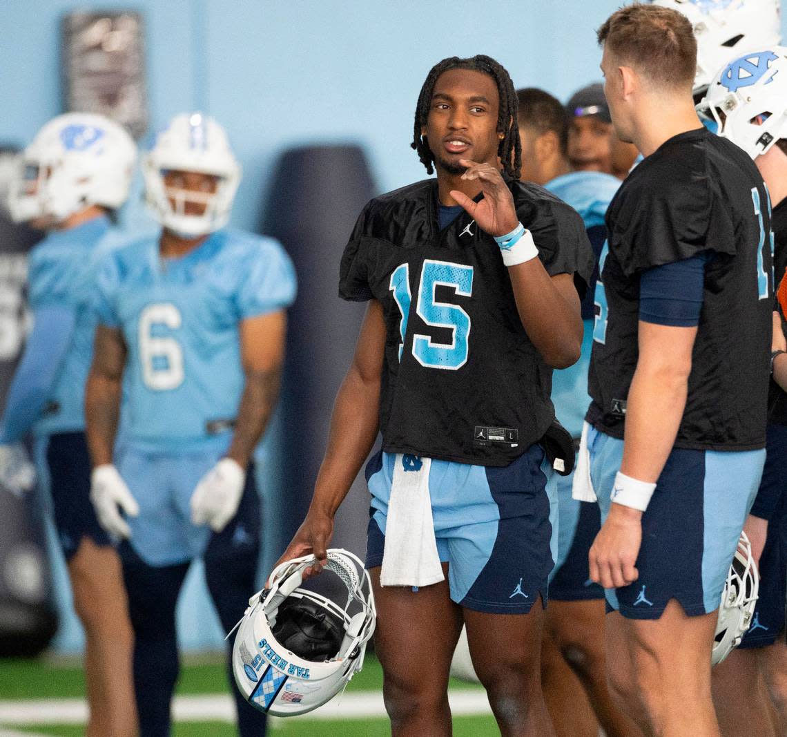 North Carolina sophomore quarterback Conner Harrell (15) talks with graduate transfer quarterback Max Johnson (14) during the Tar Heels’ opening day of spring football practice on Tuesday, March 19, 2024 in Chapel Hill, N.C. Robert Willett/rwillett@newsobserver.com