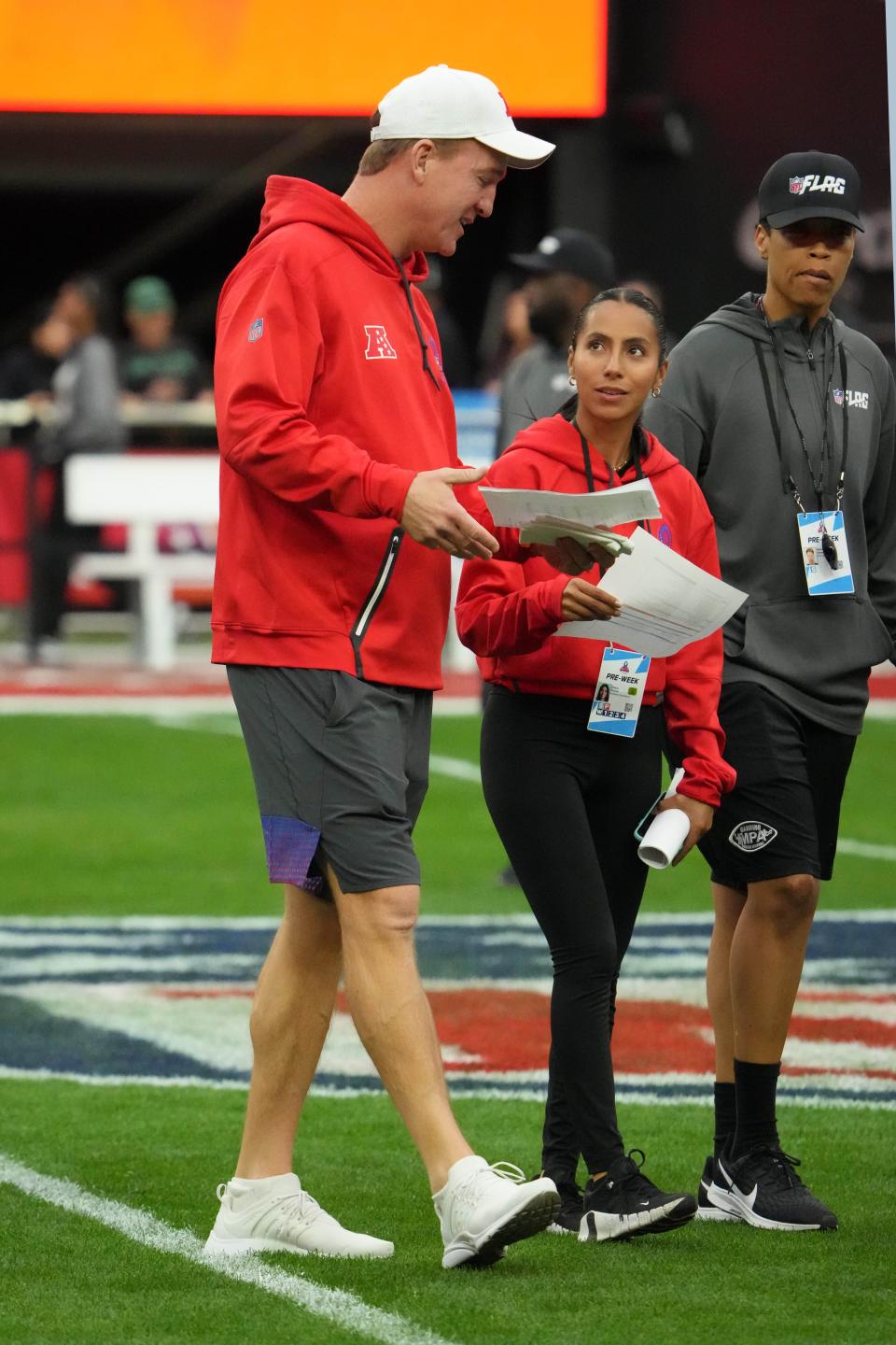 AFC coach Peyton Manning and offensive coordinator Diana Flores walk on the field during Pro Bowl Games practice at Allegiant Stadium.