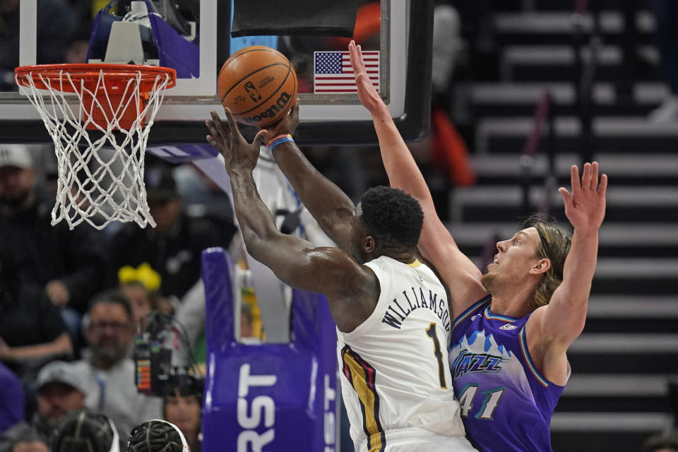 Utah Jazz forward Kelly Olynyk (41) guards New Orleans Pelicans forward Zion Williamson (1) as he goes to the basket during the first half of an NBA basketball game Thursday, Dec. 15, 2022, in Salt Lake City. (AP Photo/Rick Bowmer)