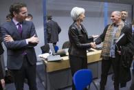 Eurogroup President Jeroen Dijsselbloem (L) looks at Greek Finance Minister Yanis Varoufakis (C) and International Monetary Fund (IMF) Managing Director Christine Lagarde (R) during an extraordinary euro zone Finance Ministers meeting to discuss Athens' plans to reverse austerity measures agreed as part of its bailout, in Brussels February 11, 2015. REUTERS/Yves Herman