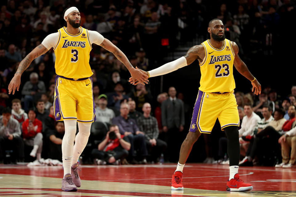 PORTLAND, OREGON - NOVEMBER 17: Anthony Davis #3 and LeBron James #23 of the Los Angeles Lakers react after a basket against the Portland Trail Blazers during the fourth quarter at Moda Center on November 17, 2023 in Portland, Oregon. NOTE TO USER: User expressly acknowledges and agrees that, by downloading and or using this photograph, User is consenting to the terms and conditions of the Getty Images License Agreement. (Photo by Steph Chambers/Getty Images)