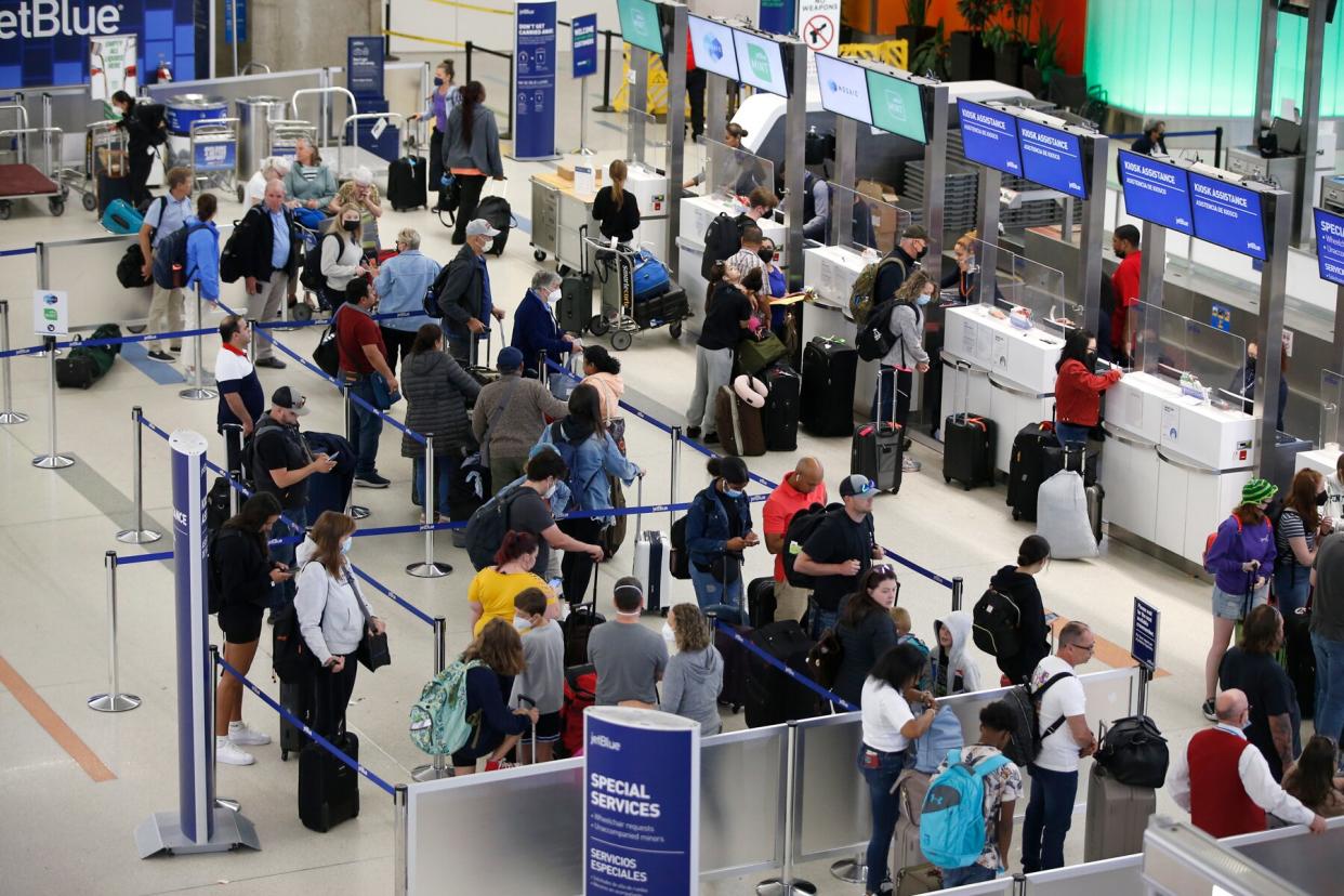 People wait in line to check in at Bostons Logan International Airport in Boston