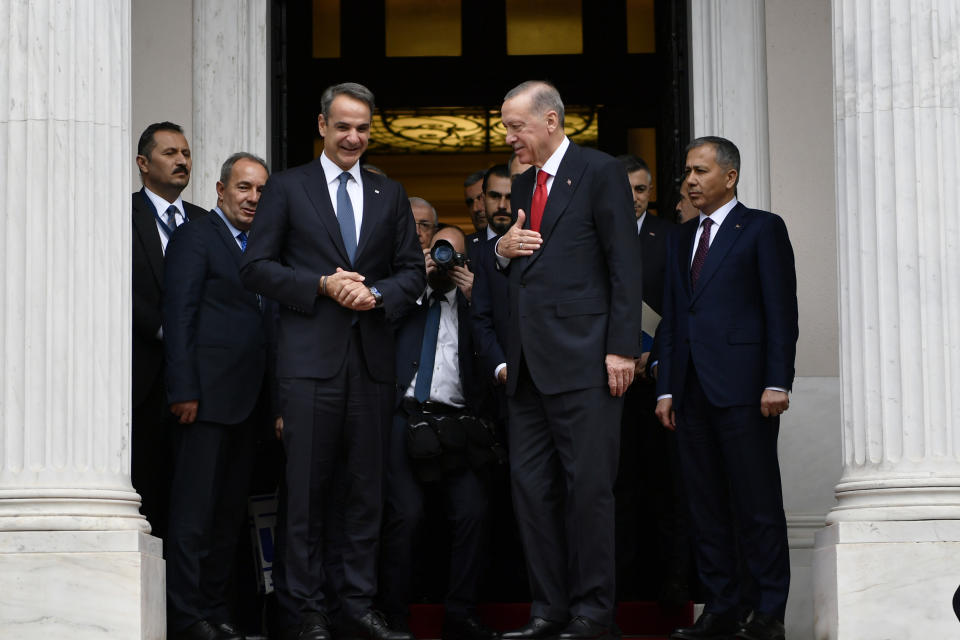 Turkey's President Recep Tayyip Erdogan, right, leaves after his meeting with Greece's Prime Minister Kyriakos Mitsotakis, left, at Maximos Mansion in Athens, Greece, Thursday, Dec. 7, 2023. After several years of strained relations that raised tensions to alarming levels, longtime regional rivals Greece and Turkey have made a significant step in mending ties during a visit to Athens by Turkish President Recep Tayyip Erdogan. (AP Photo/Michael Varaklas)