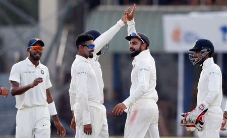 Cricket - Sri Lanka v India - First Test Match - Galle, Sri Lanka - July 27, 2017 - India's captain Virat Kohli celebrates with his teammates the wicket of Sri Lanka's Upul Tharanga. REUTERS/Dinuka Liyanawatte