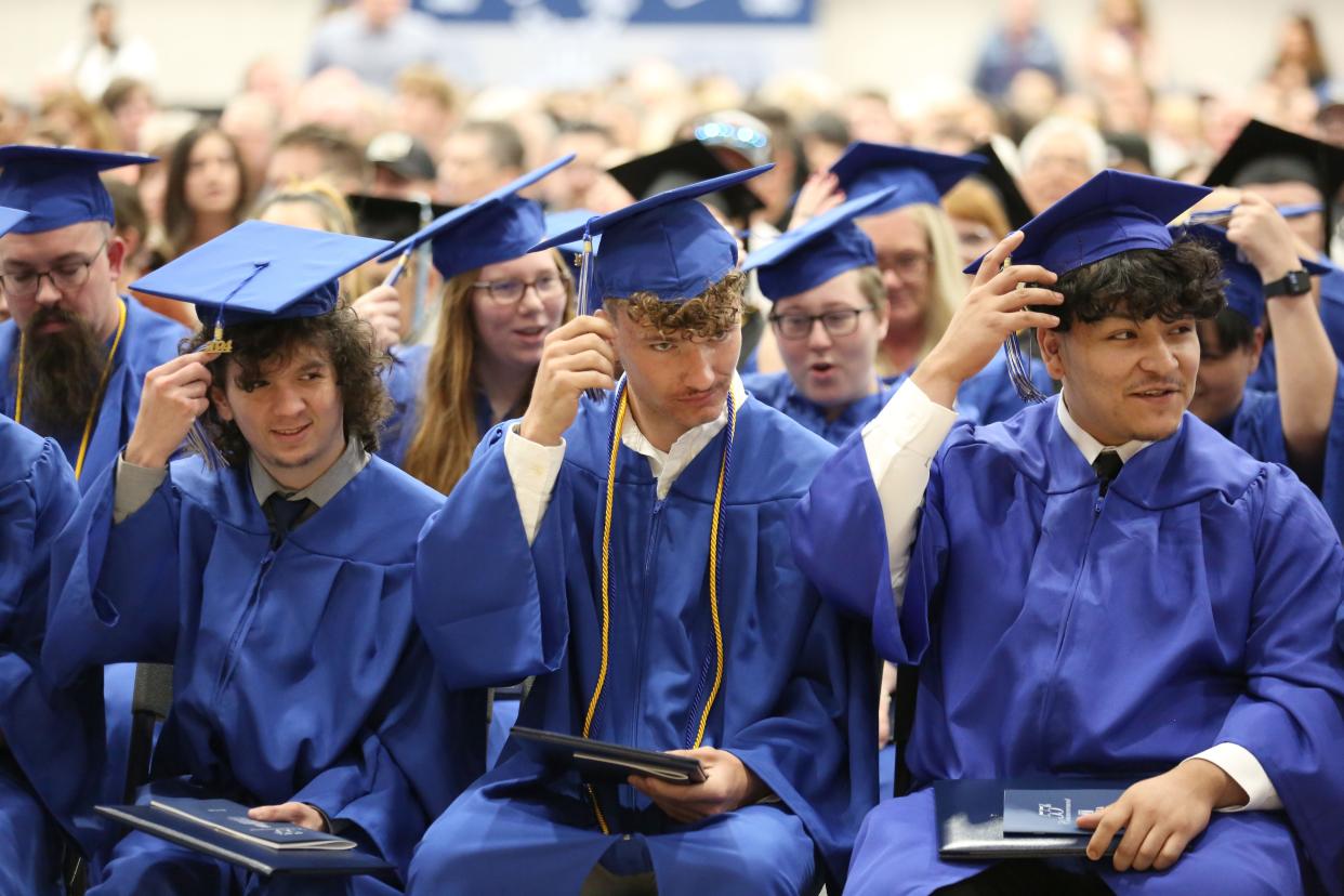 From left, graduates Tony Rodriguez, Jon Trusty, and Adrian Garcia flip their tassels at the 55th Commencement of Terra State Community College on May 10.