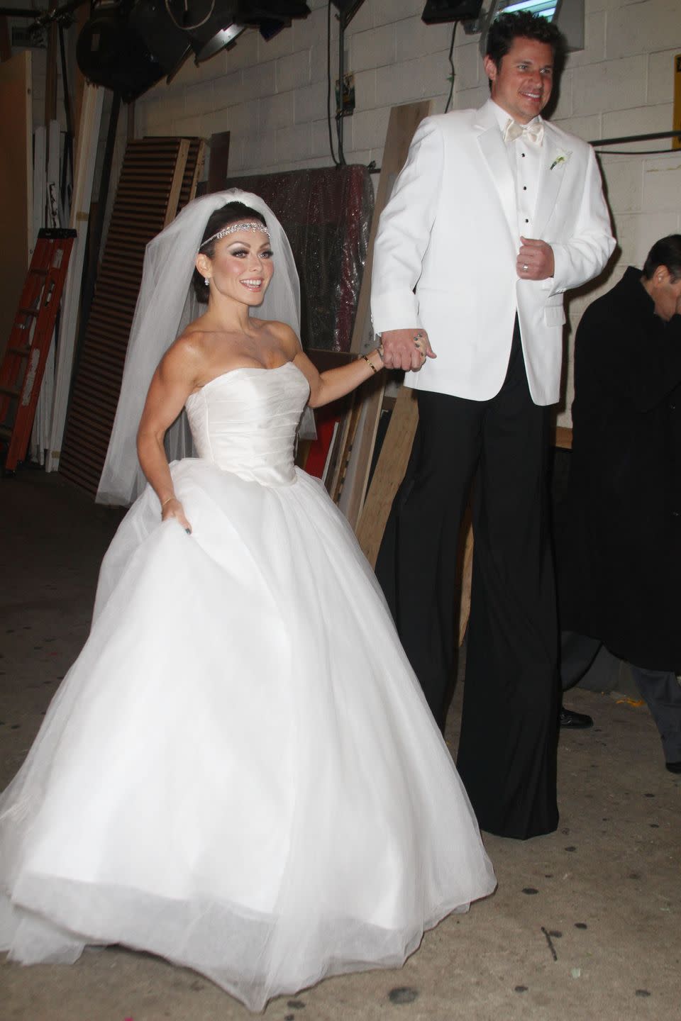 <p>TV host Kelly Ripa slayed in her Halloween costume as blushing bride Kim Kardashian with Nick Lachey as groom Kris Humphries towering above at the ABC TV studios in 2011.</p>