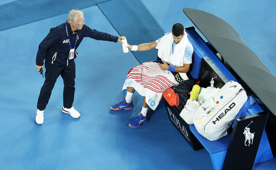 Novak Djokovic, pictured here being handed the drink bottle by the tournament supervisor at the Australian Open.