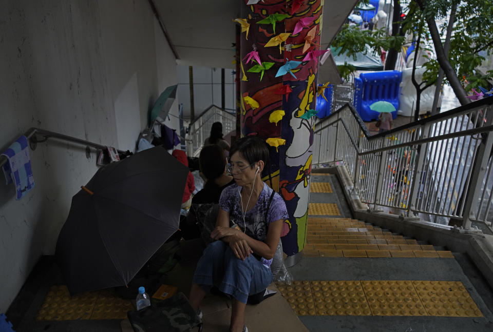 A protester takes a rest during a sit-in outside police headquarters in Hong Kong Monday, Oct. 14, 2019. The protests that started in June over a now-shelved extradition bill have since snowballed into an anti-China campaign amid anger over what many view as Beijing's interference in Hong Kong's autonomy that was granted when the former British colony returned to Chinese rule in 1997. (AP Photo/Vincent Yu)