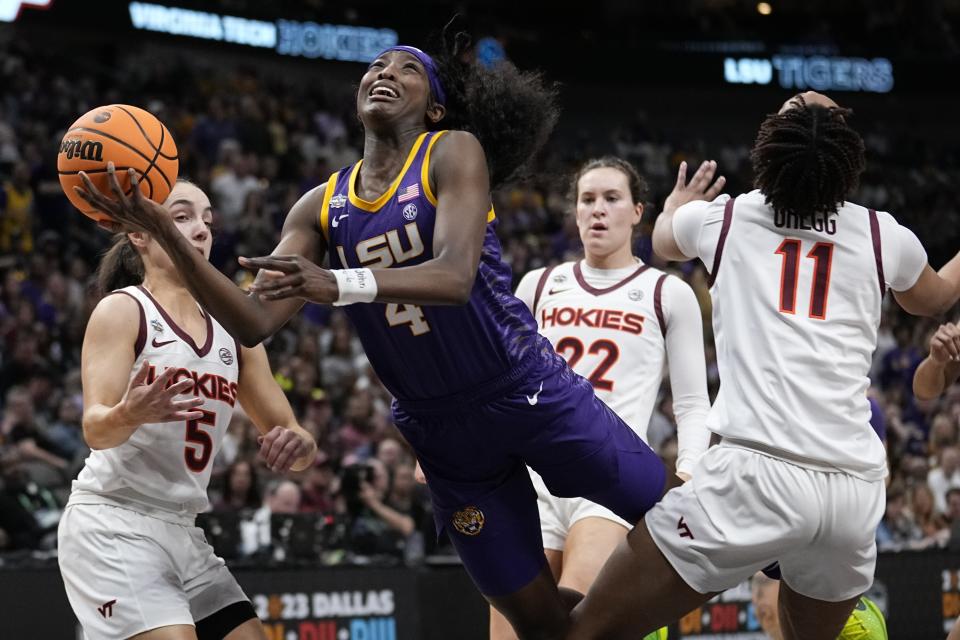 LSU's Flau'jae Johnson loses the ball as she drives past Virginia Tech's Cayla King, D'asia Gregg and Georgia Amoore during the first half of an NCAA Women's Final Four semifinals basketball game Friday, March 31, 2023, in Dallas. (AP Photo/Tony Gutierrez)