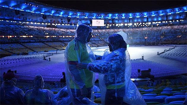 Spectators wearing raincoats gather for the closing ceremony of the Rio 2016 Olympic Games at the Maracana stadium. Pic: AFP