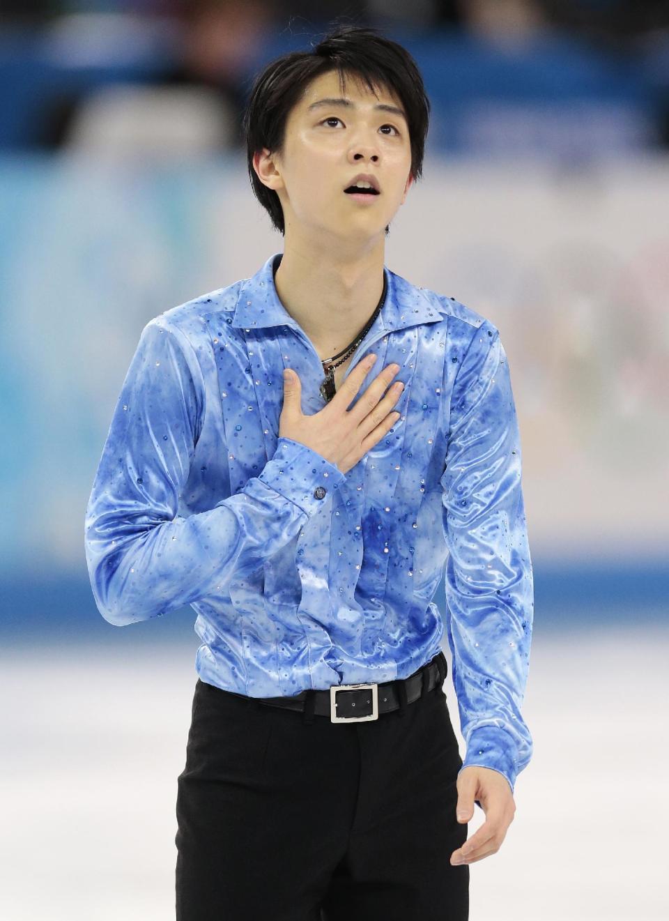 Yuzuru Hanyu of Japan gestures after competing in the men's team short program figure skating competition at the Iceberg Skating Palace during the 2014 Winter Olympics, Thursday, Feb. 6, 2014, in Sochi, Russia. (AP Photo/Ivan Sekretarev)