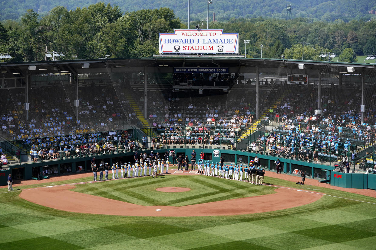 Curacao, on the third base line, and Honolulu, on the first base line, are introduced before the Little League World Series Championship game at Lamade Stadium in South Williamsport, Pa., Sunday, Aug. 28, 2022. (AP Photo/Tom E.Puskar)