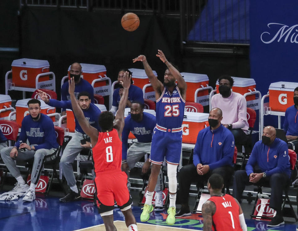 New York Knicks forward Reggie Bullock (25) shoots against the Houston Rockets during the first quarter of an NBA basketball game Saturday, Feb. 13, 2021, in New York. (Wendell Cruz/Pool Photo via AP)