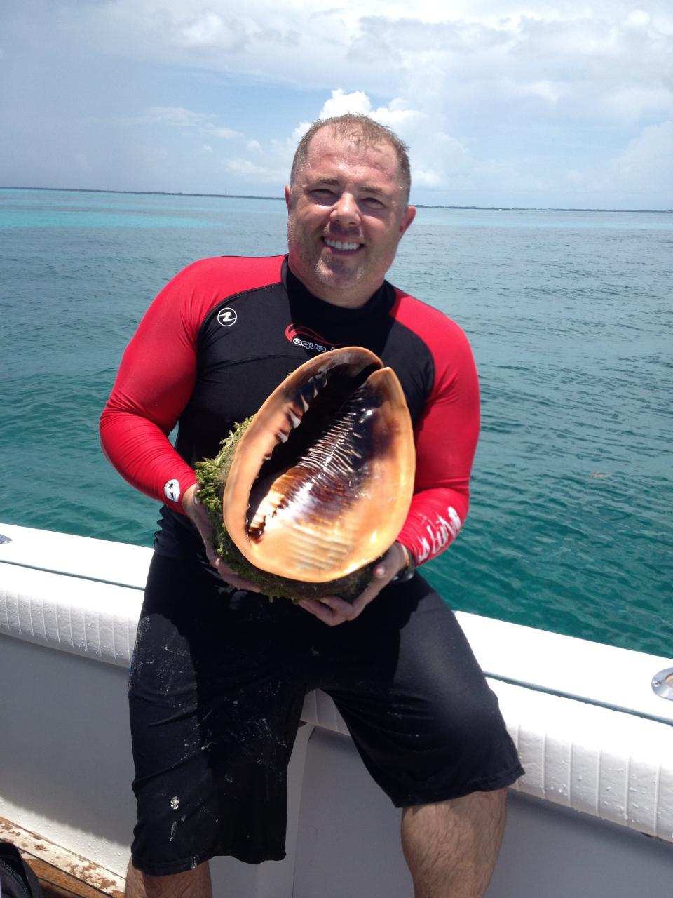 Mark Johnson of Wilmington shows off a Queen's Helmet he found while scuba diving off the Florida Keys. Johnson, president of the North Carolina Shell Club, said he's found Queen's Helmet shells off the coast of North Carolina, as well.