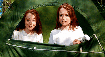 Identical twins peer out from a tent in a scene from 'The Parent Trap.'