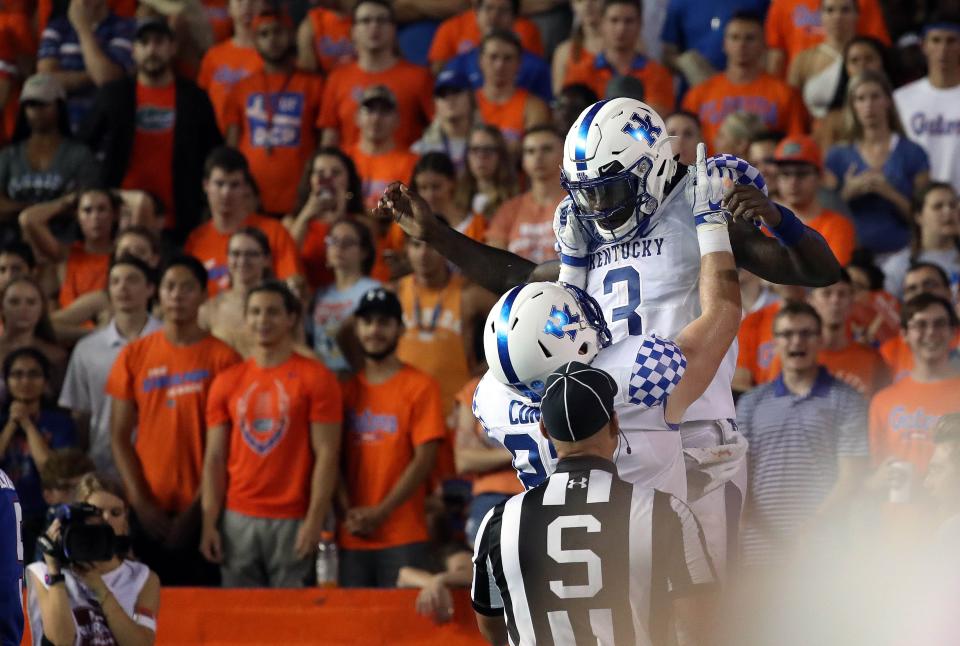 Kentucky quarterback Terry Wilson (3) is congratulated after scoring against Florida in 2018 in The Swamp.