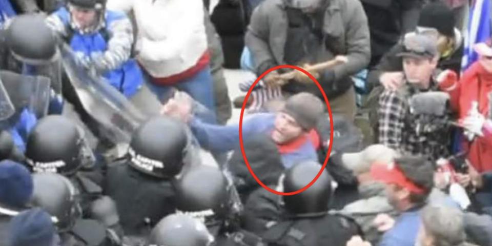 A screenshot from footage, shot from above, of police attempting to halt rioters outside the Capitol. The man who FBI believes is Landon Copeland is circled.