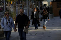 People walk at Makarios III street, a main shopping street, in central capital Nicosia, Cyprus, Wednesday, Jan. 24, 2024. Official figures show Cyprus making significant headway in weaning itself off Russian cash and business as it tries to clean up its image as a favorite destination for Moscow's money. According to the figures, the number of Russian clients using Cypriot banks has dropped 82% between 2014 up until the end of 2022. (AP Photo/Petros Karadjias)