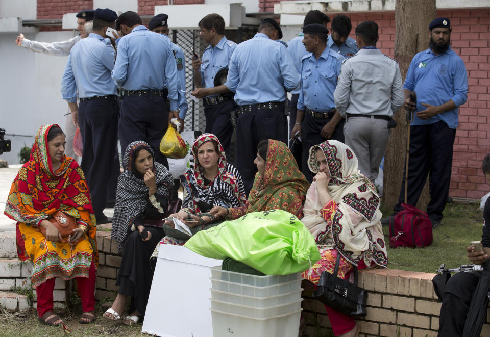 Pakistani election staff wait for a transport to carry material to polling stations at a distribution center in Islamabad, Pakistan, Tuesday, July 24, 2018. As Pakistan prepares to make history Wednesday by electing a third straight civilian government, rights activists, analysts and candidates say the campaign has been among its dirtiest ever, imperiling the country's wobbly transition to democratic rule. (AP Photo/B.K. Bangash)