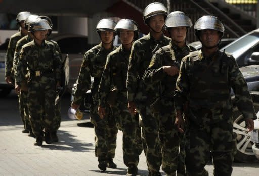 Chinese paramilitary police are seen on patrol in Urumqi, capital of China's Xinjiang region, in 2010. Knife-wielding attackers killed 13 people in China's Xinjiang region and another five were shot dead by police as a wave of violence swept the ethnically-torn area, state media and officials said Sunday