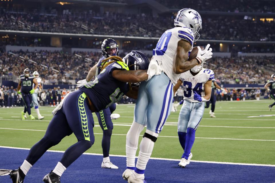 Dallas Cowboys wide receiver Brandon Smith (80) catches a touchdown pass as Seattle Seahawks linebacker Lakiem Williams defends in the second half of a preseason NFL football game in Arlington, Texas, Friday, Aug. 26, 2022. (AP Photo/Ron Jenkins)