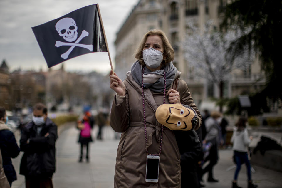 People protest against a law to legalize euthanasia in front of the Spanish Parliament in Madrid, Spain, Thursday, Dec. 17, 2020. The Spanish Parliament debates on votes on a bill to legalize euthanasia for those people suffering "unbearably" from a chronic or incurable disease. (AP Photo/Manu Fernandez)