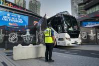 An empty player bus departs Scotiabank Arena in Toronto on Thursday, Aug. 27, 2020. The NHL postponed two days of playoff games Thursday after withering criticism from Black players who said the league was slow to acknowledge the police shooting of Jacob Blake in Wisconsin. (Frank Gunn/The Canadian Press via AP)