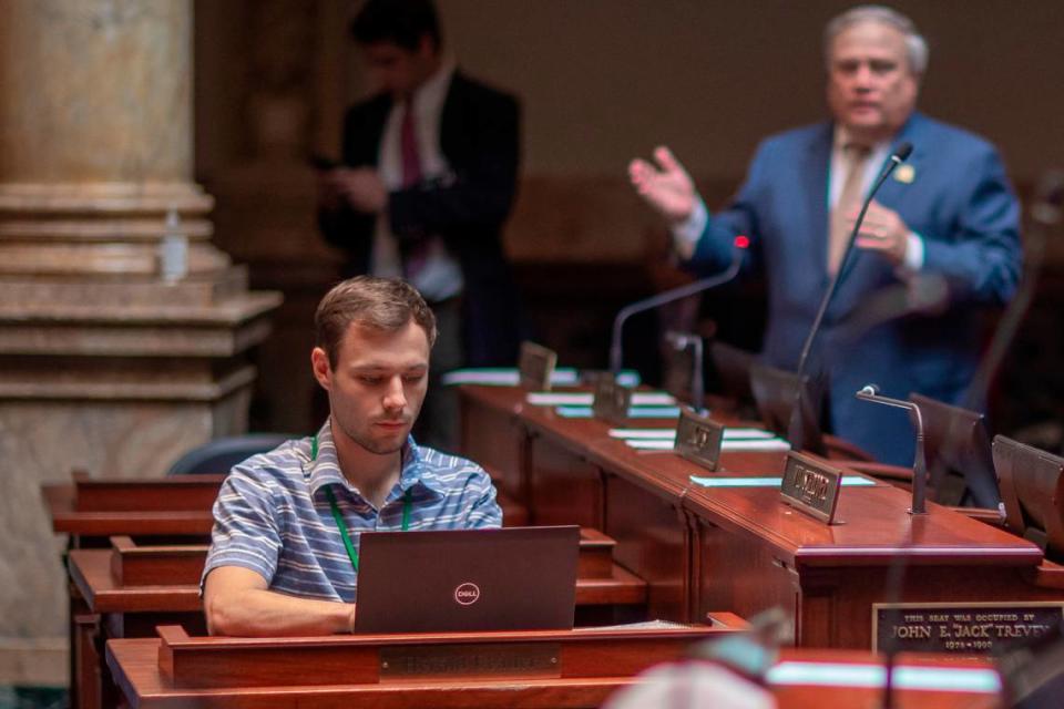 Lexington Herald-Leader political reporter Austin Horn at his desk on the floor of the Senate Chambers in the State Capitol in Frankfort, Ky.