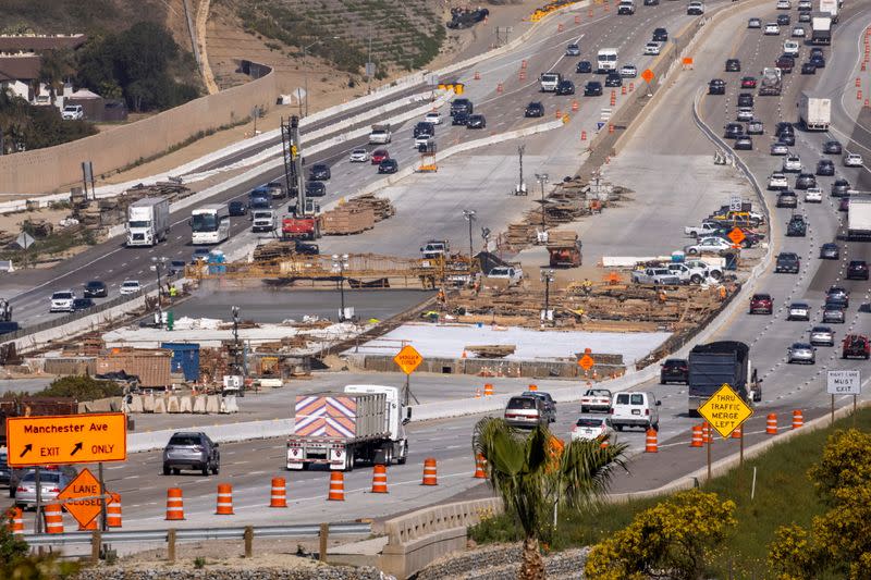 Work crews continue to work on the construction of a freeway overpass in Encinitas
