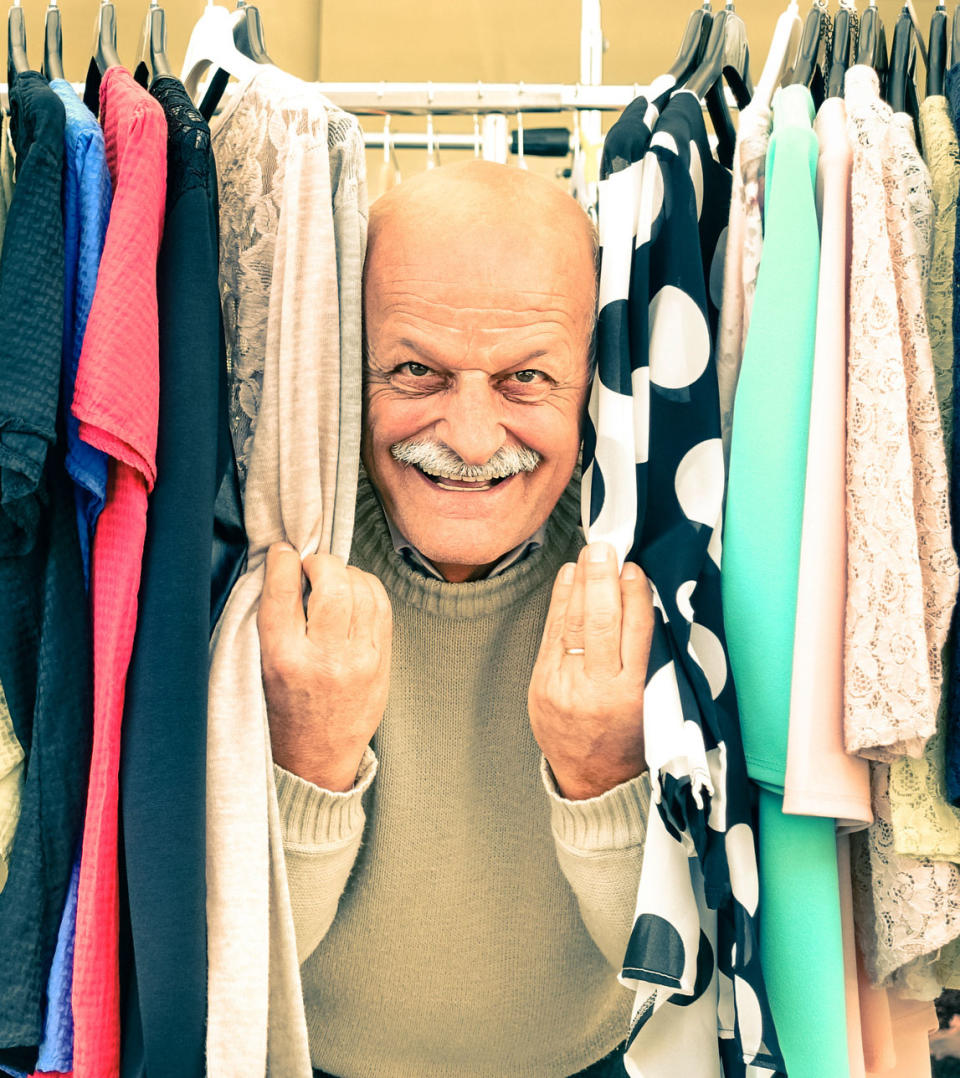 Playful senior couple at weakly flea market - Concept of active elderly with mature man and woman having fun and shopping in the old town - Happy retirement moments on a warm vintage nostalgic look