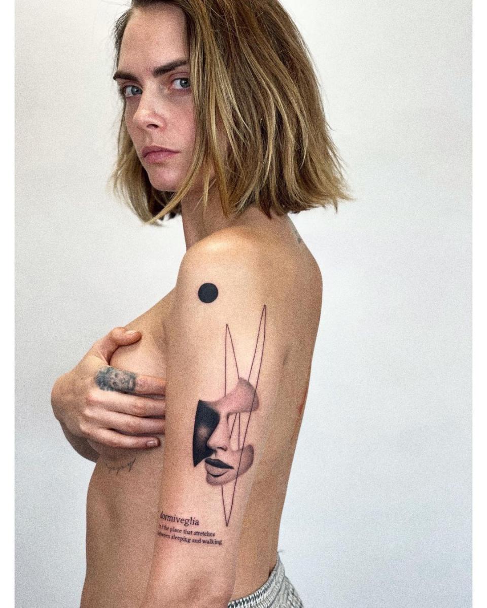 Cara Delevingne poses topless for new tattoo