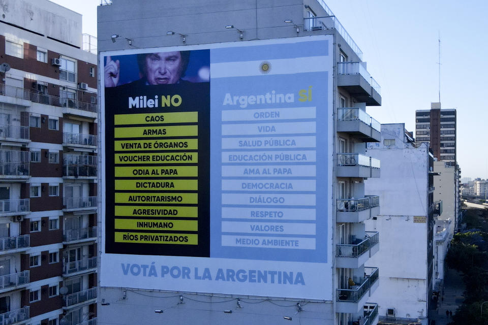 A campaign ad listing the cons of presidential candidate Javier Miler if elected, posted by the campaign of Economy Minister Sergio Massa, the ruling party's presidential candidate, in Buenos Aires, Argentina, Tuesday, Nov. 14, 2023. As Argentina heads for a presidential Nov. 19 runoff election, the decades-old populist movement known as Peronism has Massa working overtime to keep once-steadfast supporters from straying to his opponent, right-wing populist Javier Milei. (AP Photo/Natacha Pisarenko)