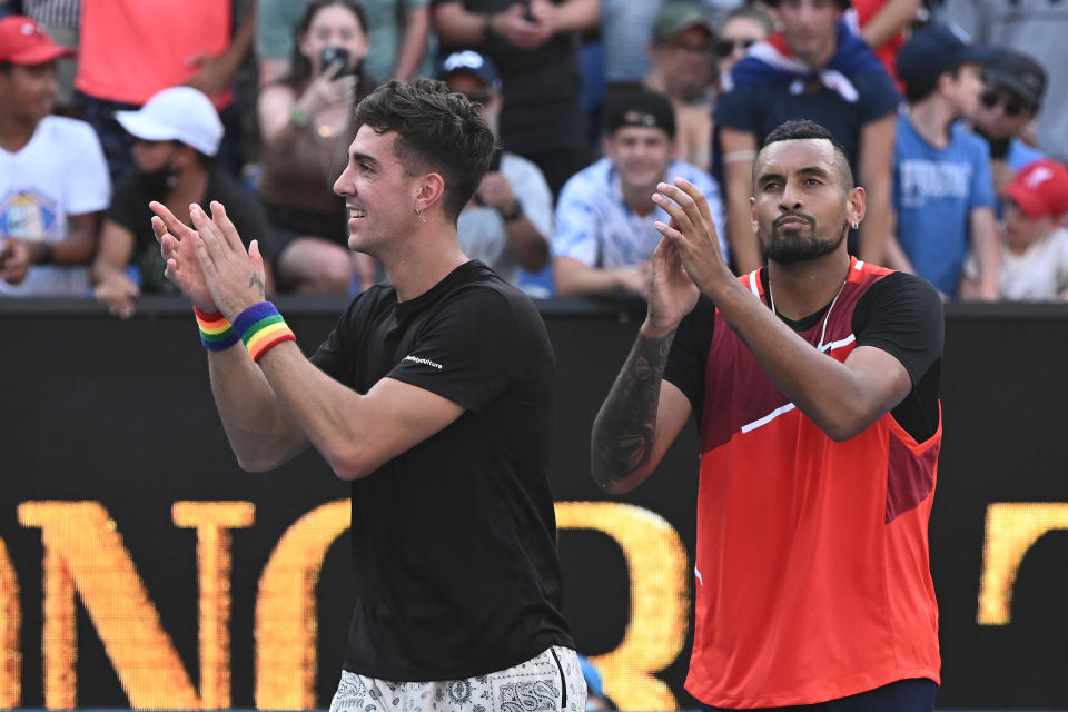 Thanasi Kokkinakis (pictured left) and Nick Kyrgios (pictured right) acknowledge the crowd after winning their third round doubles match.