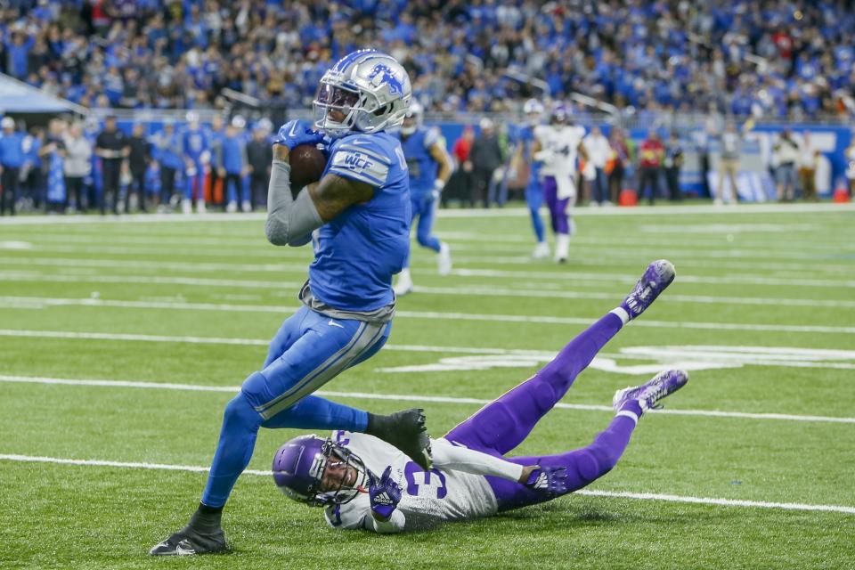 Detroit Lions' DJ Chark catches a touchdown pass in front of Minnesota Vikings' Cameron Dantzler Sr. during the first half of an NFL football game Sunday, Dec. 11, 2022, in Detroit. (AP Photo/Duane Burleson)