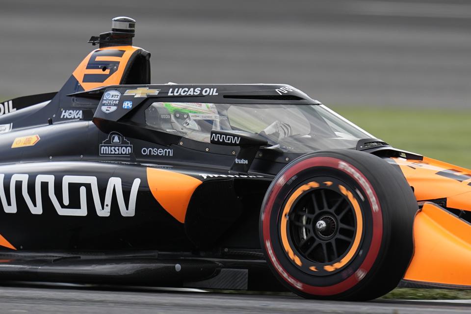 Pato O'Ward, of Mexico, drives into a turn during qualifications for the IndyCar Grand Prix auto race at Indianapolis Motor Speedway, Friday, May 10, 2024, in Indianapolis. (AP Photo/Darron Cummings)